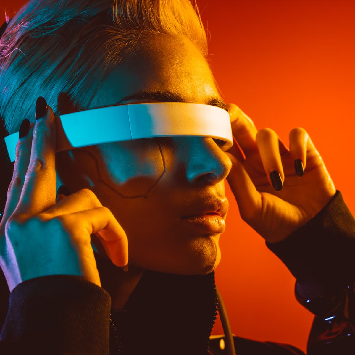 Person in futuristic glasses under artificial studio light