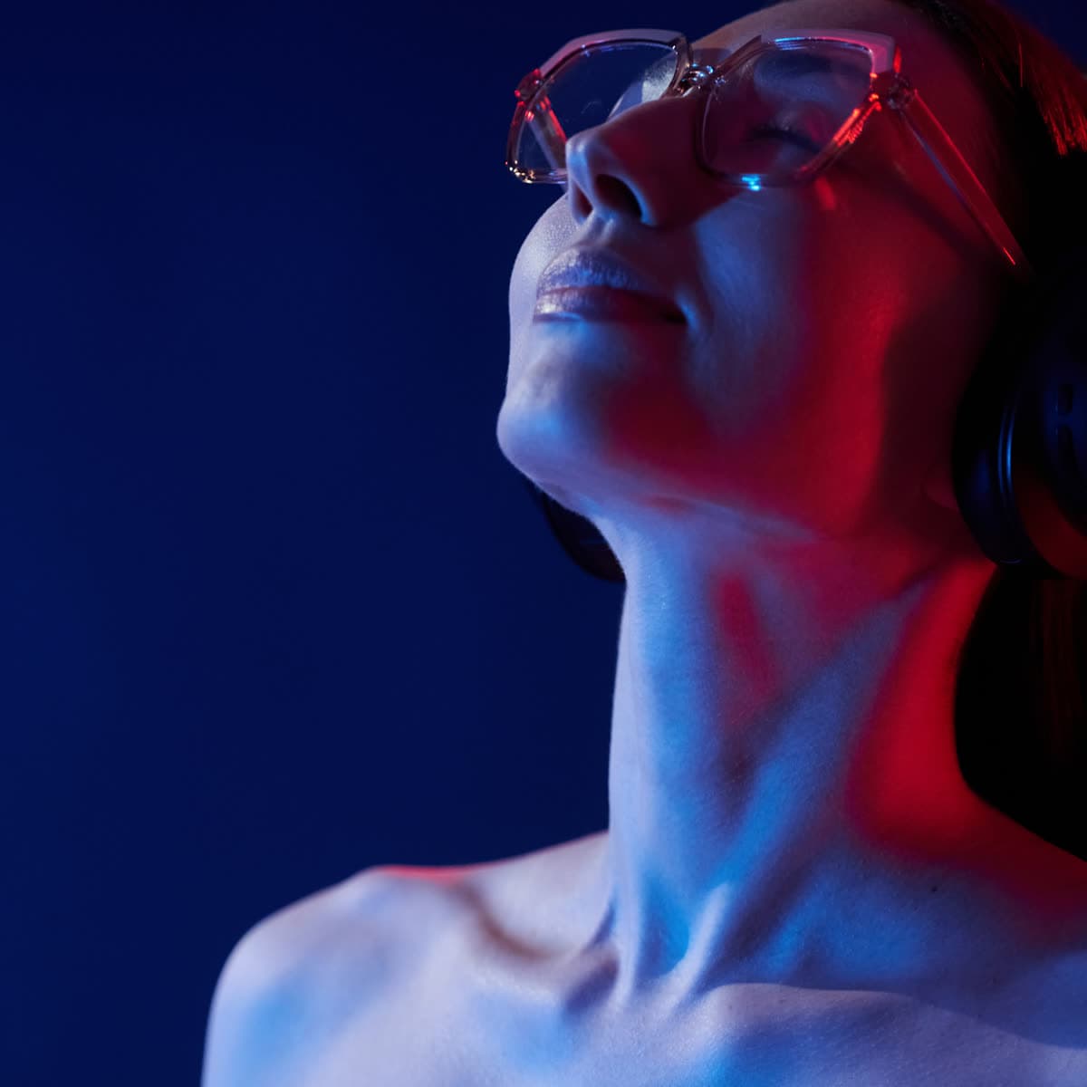 Listener immersed in ambient music with neon studio light