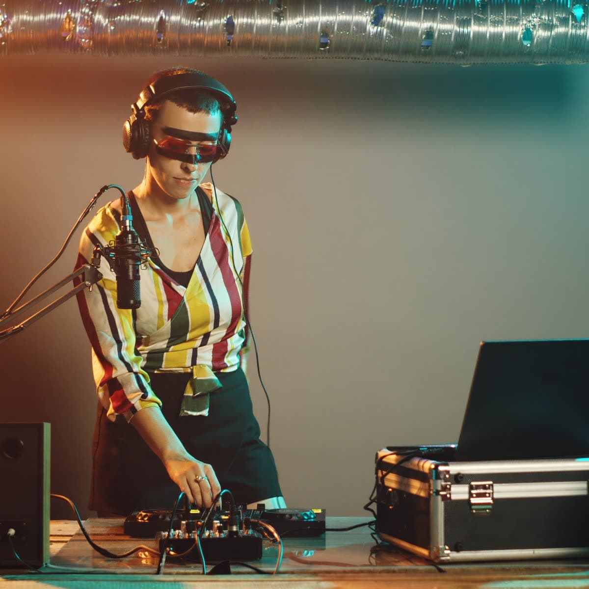 Mix engineer wearing headphones at a sound console