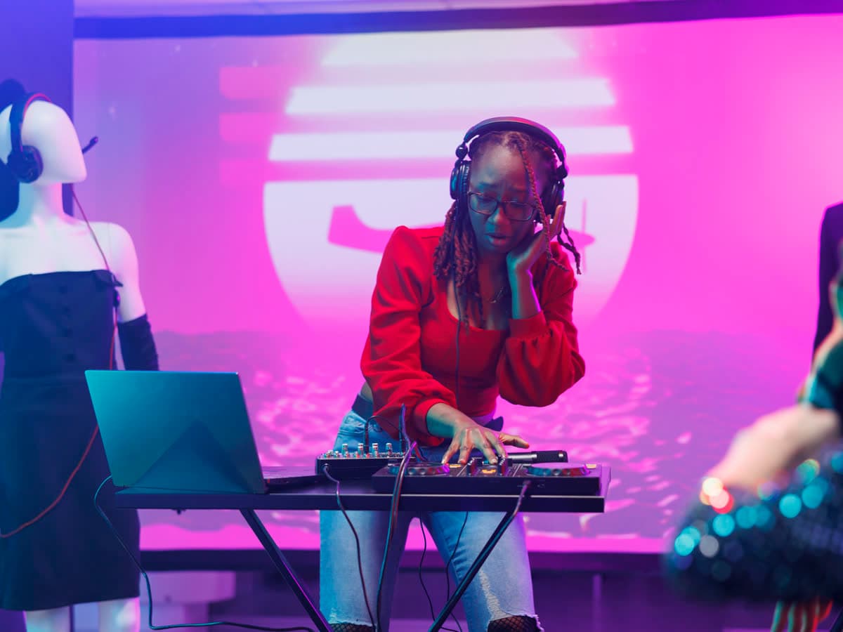 DJ mixing electronic music under stage lights
